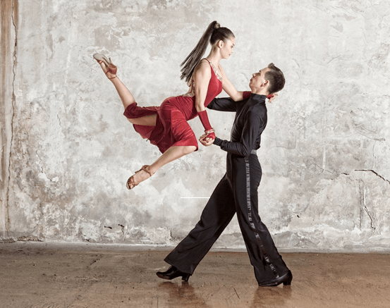 Flexible young modern dance couple posing in studio. - Stock Image -  Everypixel